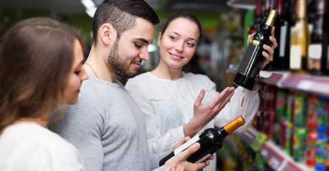 Solicitor Training 2024 image of 3 people looking at wine bottles on shelves