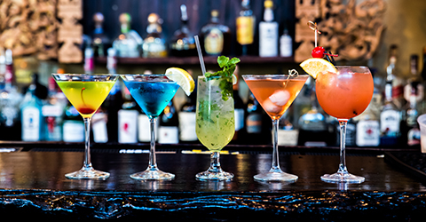 Cocktails lined up on a bar